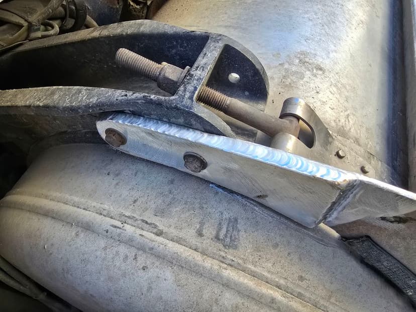Close-up of a metal bracket and joint assembly on industrial machinery.