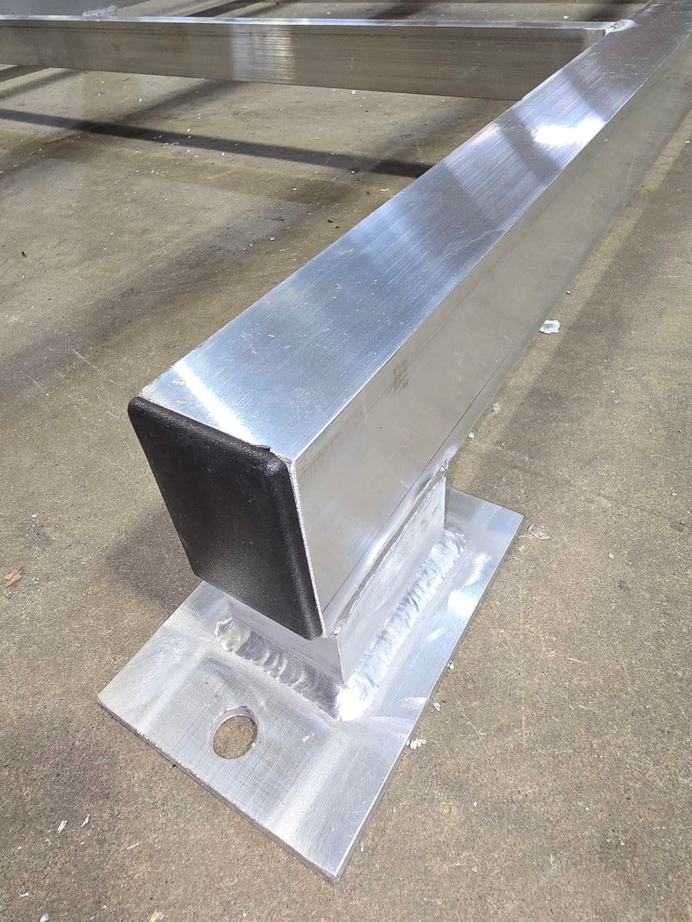 Aluminum rail with welded base, showcasing durable silver finish and robust design.